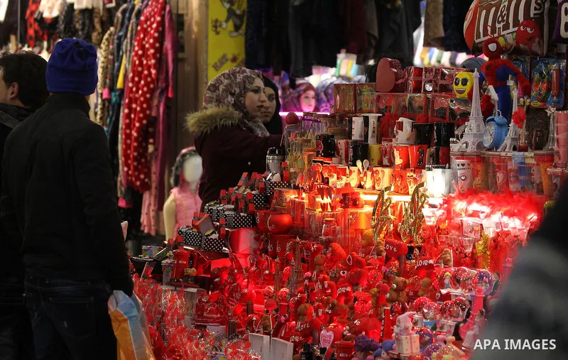 Palestinian vendors display red teddy bears, red ballons and pillows on Valentine's day in the West Bank city of Hebron on February 14, 2017. Valentine's Day is increasingly popular in the region as people have taken up...