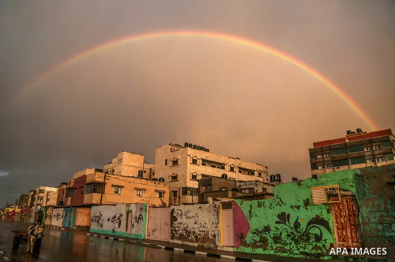 A picture taken on February 15, 2017 shows a rainbow appearing over Al-Shati refugee camp in Gaza City. Photo by Mohammed Dahman