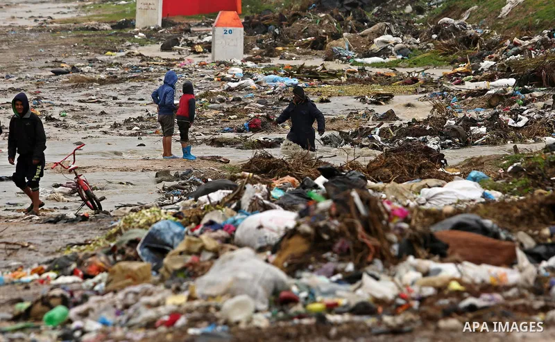 Palestinian children walk in a flooded area following heavy rainfall, in the al-Moghraqa in the center Gaza Strip, on February 16, 2017. Photo by Ashraf Amra