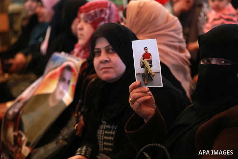 Palestinians hold placards during a protest to show solidarity with Palestinian prisoners held in Israeli Jails, in front of Red cross office in Gaza city, on February 20, 2017. Photo by Mohammed Asad