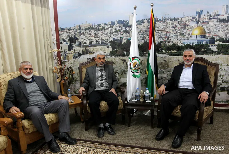 A handout picture released on February 21, 2017 by the office of Gaza's senior Hamas leader Ismail Haniya shows him meeting with freed Palestinian prisoner and newly elected Hamas armed wing Gaza head, Yahya Sinwar, in G...