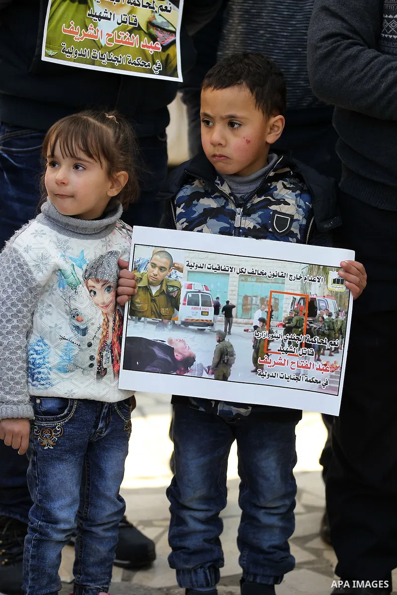Palestinians take part in a demonstration following a verdict in the trial of the Israeli soldier Elor Azaria who in March 2016 shot dead wounded alleged Palestinian assailant Abdul Fatah al-Sharif as he lay on the groun...