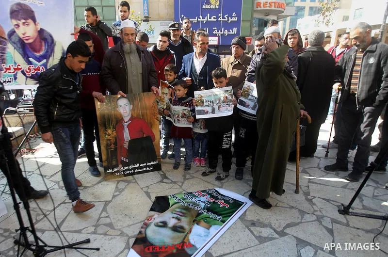Palestinians take part in a demonstration following a verdict in the trial of the Israeli soldier Elor Azaria who in March 2016 shot dead wounded alleged Palestinian assailant Abdul Fatah al-Sharif as he lay on the groun...