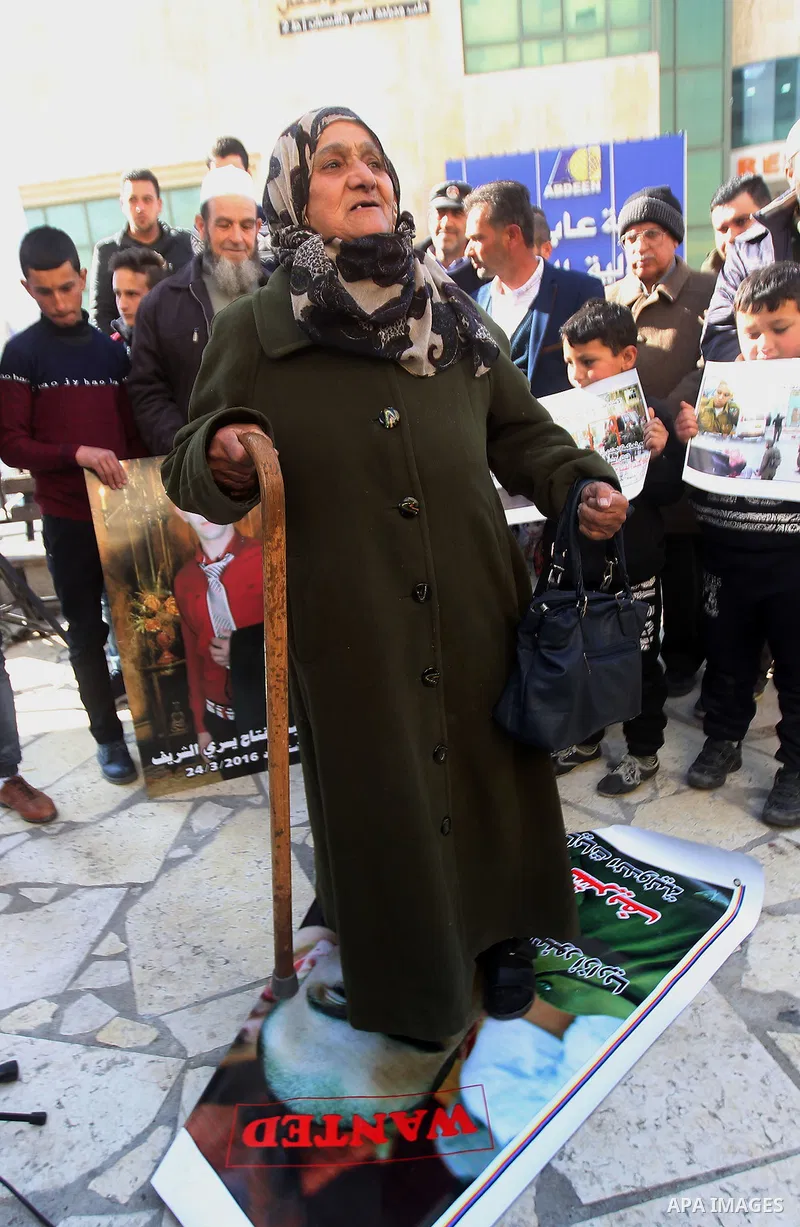 A Palestinian woman reacts during a demonstration following a verdict in the trial of the Israeli soldier Elor Azaria who in March 2016 shot dead wounded alleged Palestinian assailant Abdul Fatah al-Sharif as he lay on t...