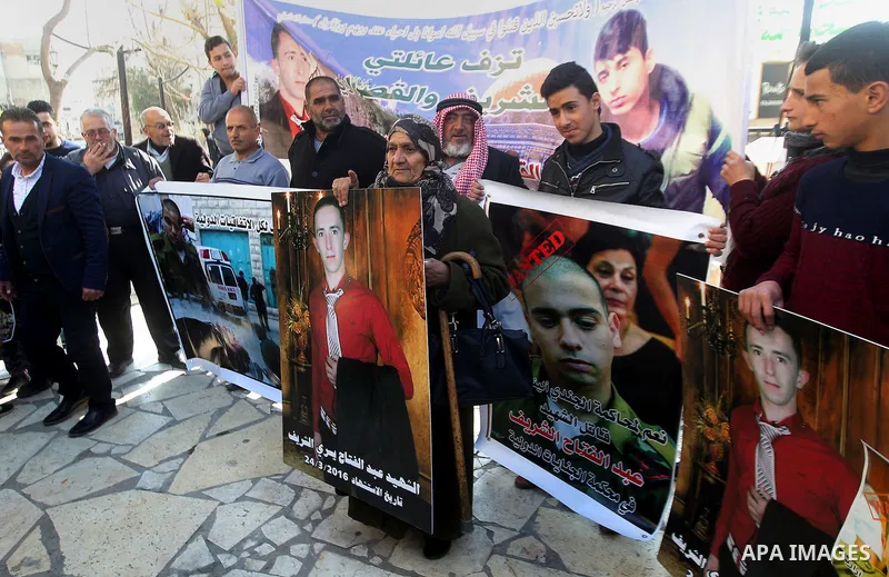 Palestinians take part in a demonstration following a verdict in the trial of the Israeli soldier Elor Azaria who in March 2016 shot dead wounded alleged Palestinian assailant Abdul Fatah al-Sharif as he lay on the groun...