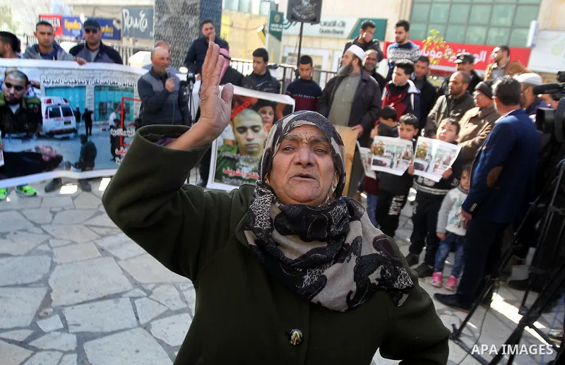 A Palestinian woman reacts during a demonstration following a verdict in the trial of the Israeli soldier Elor Azaria who in March 2016 shot dead wounded alleged Palestinian assailant Abdul Fatah al-Sharif as he lay on t...