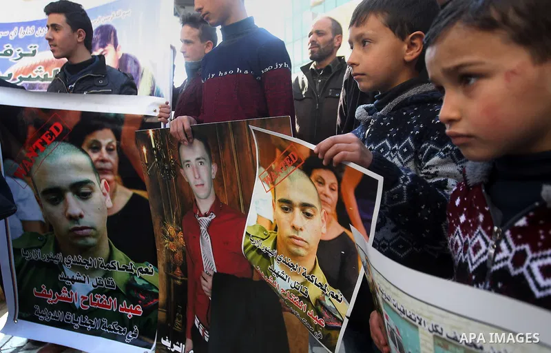Palestinians take part in a demonstration following a verdict in the trial of the Israeli soldier Elor Azaria who in March 2016 shot dead wounded alleged Palestinian assailant Abdul Fatah al-Sharif as he lay on the groun...