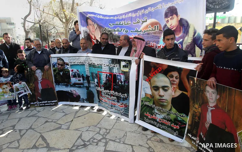 Palestinians take part in a demonstration following a verdict in the trial of the Israeli soldier Elor Azaria who in March 2016 shot dead wounded alleged Palestinian assailant Abdul Fatah al-Sharif as he lay on the groun...