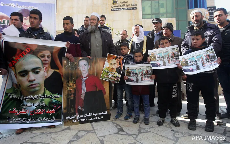 Palestinians take part in a demonstration following a verdict in the trial of the Israeli soldier Elor Azaria who in March 2016 shot dead wounded alleged Palestinian assailant Abdul Fatah al-Sharif as he lay on the groun...