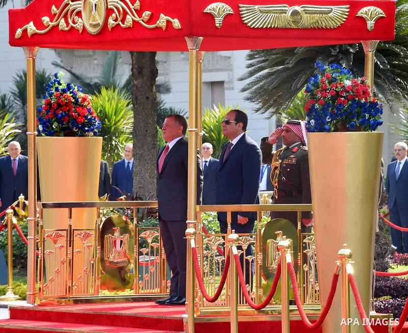 A handout picture released by the Jordanian Royal Palace on February 21, 2017, shows Jordan's King Abdullah II (C) reviewing the honour guard alongside Egyptian President Abdel Fattah al-Sisi during a meeting in Cairo. P...