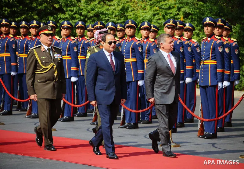 A handout picture released by the Jordanian Royal Palace on February 21, 2017, shows Jordan's King Abdullah II (C) reviewing the honour guard alongside Egyptian President Abdel Fattah al-Sisi during a meeting in Cairo. P...