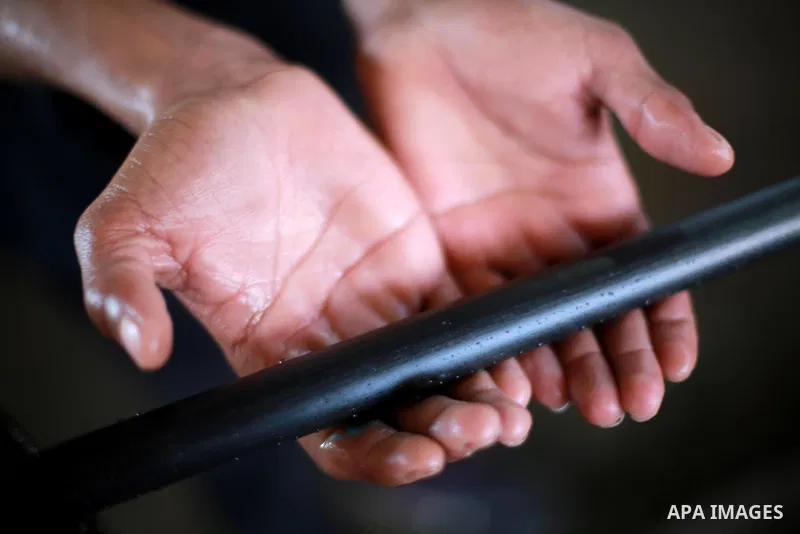 A Palestinian worker reuses plastics and metals to produce water hoses at a factory, in Gaza city, February 22, 2017. Workers collect the household recyclables, metals and plastic from landfill and garbage to sell to the...