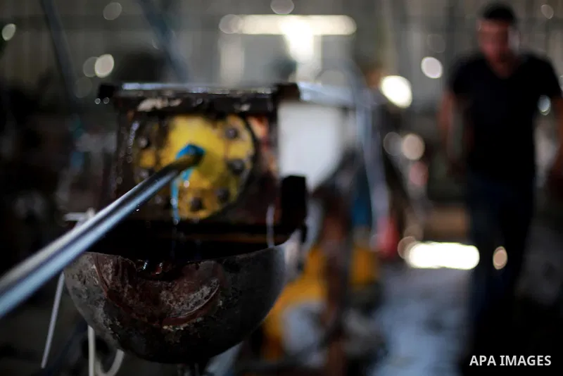 A Palestinian worker reuses plastics and metals to produce water hoses at a factory, in Gaza city, February 22, 2017. Workers collect the household recyclables, metals and plastic from landfill and garbage to sell to the...