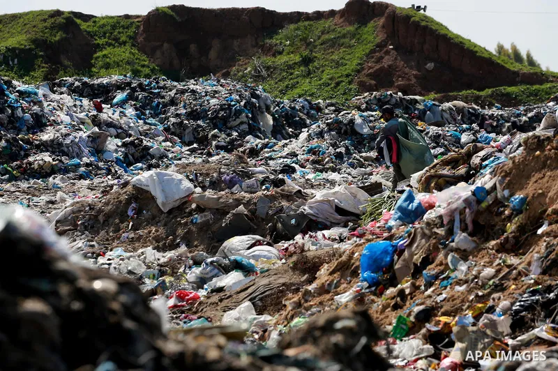 A Palestinian man collects plastics and metals from a pile of waste in Gaza city, February 22, 2017. Workers collect the household recyclables, metals and plastic from landfill and garbage to sell to the local factories....
