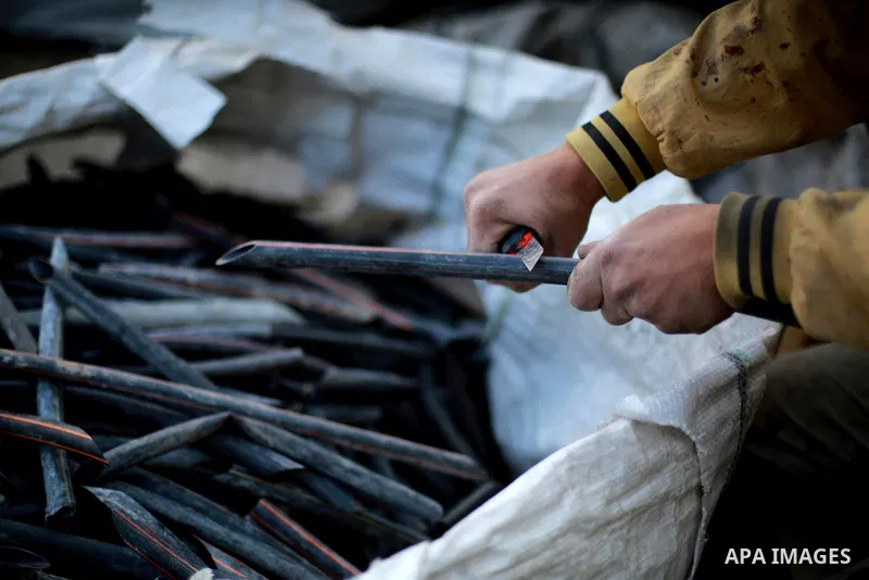 A Palestinian worker reuses plastics and metals to produce water hoses at a factory, in Gaza city, February 22, 2017. Workers collect the household recyclables, metals and plastic from landfill and garbage to sell to the...