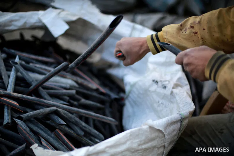 A Palestinian worker reuses plastics and metals to produce water hoses at a factory, in Gaza city, February 22, 2017. Workers collect the household recyclables, metals and plastic from landfill and garbage to sell to the...