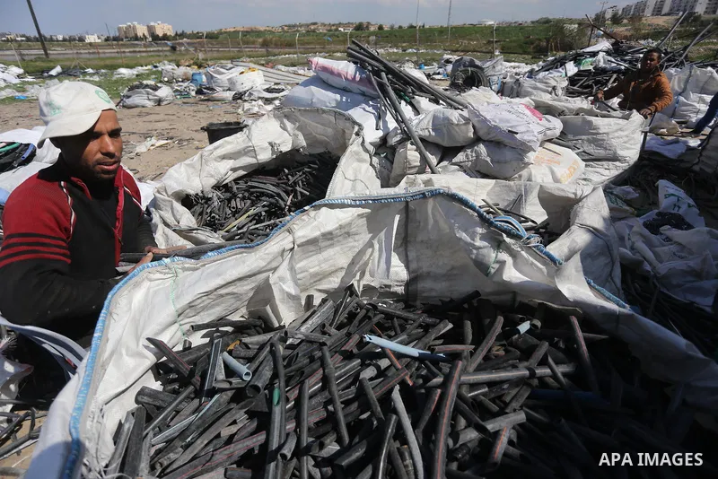 A Palestinian worker reuses plastics and metals to produce water hoses at a factory, in Gaza city, February 22, 2017. Workers collect the household recyclables, metals and plastic from landfill and garbage to sell to the...