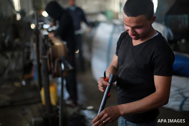 A Palestinian worker reuses plastics and metals to produce water hoses at a factory, in Gaza city, February 22, 2017. Workers collect the household recyclables, metals and plastic from landfill and garbage to sell to the...