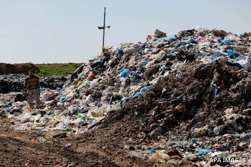 A Palestinian man collects plastics and metals from a pile of waste in Gaza city, February 22, 2017. Workers collect the household recyclables, metals and plastic from landfill and garbage to sell to the local factories....