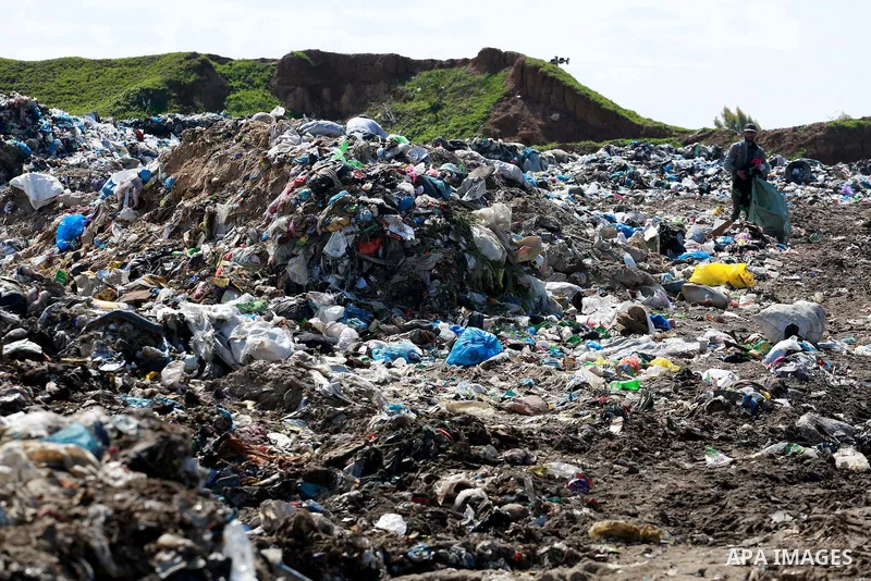 A Palestinian man collects plastics and metals from a pile of waste in Gaza city, February 22, 2017. Workers collect the household recyclables, metals and plastic from landfill and garbage to sell to the local factories....