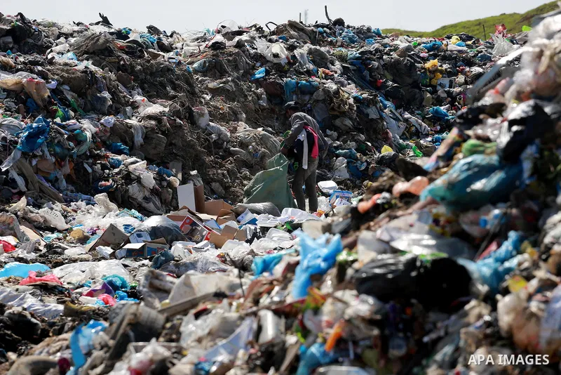 A Palestinian man collects plastics and metals from a pile of waste in Gaza city, February 22, 2017. Workers collect the household recyclables, metals and plastic from landfill and garbage to sell to the local factories....
