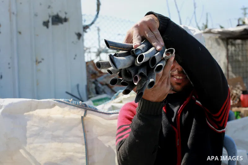 A Palestinian worker reuses plastics and metals to produce water hoses at a factory, in Gaza city, February 22, 2017. Workers collect the household recyclables, metals and plastic from landfill and garbage to sell to the...