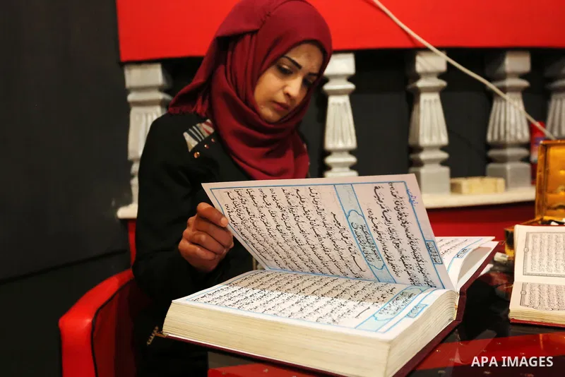 Saadia Akkad, a Palestinian woman, 25, print a copy of the Koran in a manner drawing Ottoman, at her house on February 22, 2017, in Khan Younis in the southern Gaza strip. Photo by Ashraf Amra