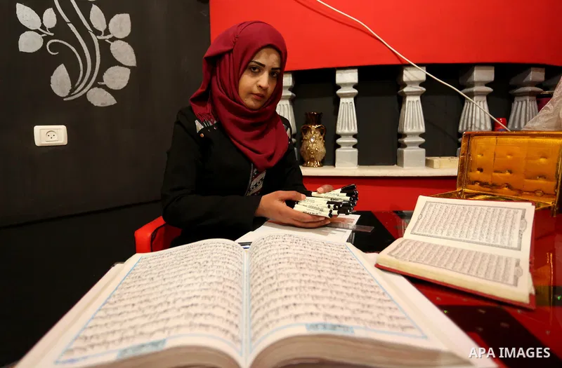 Saadia Akkad, a Palestinian woman, 25, print a copy of the Koran in a manner drawing Ottoman, at her house on February 22, 2017, in Khan Younis in the southern Gaza strip. Photo by Ashraf Amra