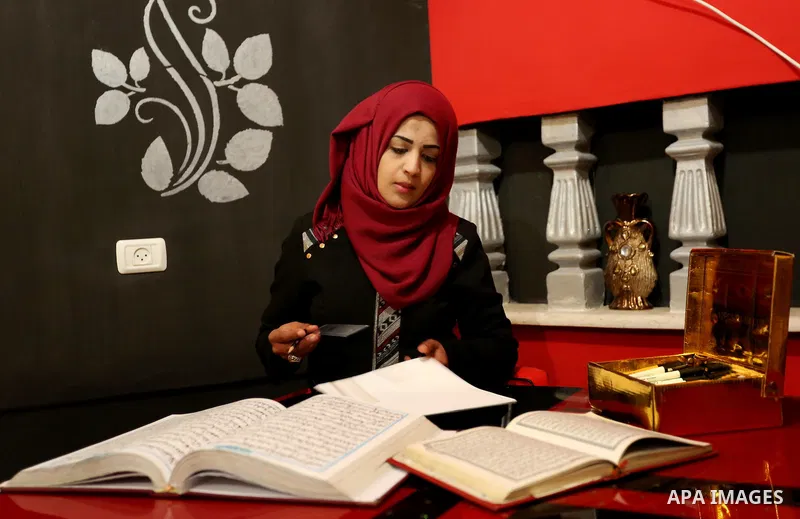 Saadia Akkad, a Palestinian woman, 25, print a copy of the Koran in a manner drawing Ottoman, at her house on February 22, 2017, in Khan Younis in the southern Gaza strip. Photo by Ashraf Amra