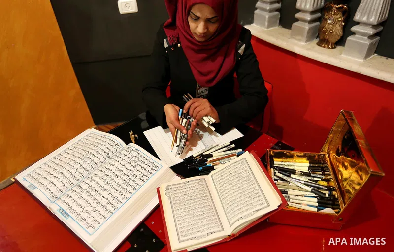 Saadia Akkad, a Palestinian woman, 25, print a copy of the Koran in a manner drawing Ottoman, at her house on February 22, 2017, in Khan Younis in the southern Gaza strip. Photo by Ashraf Amra
