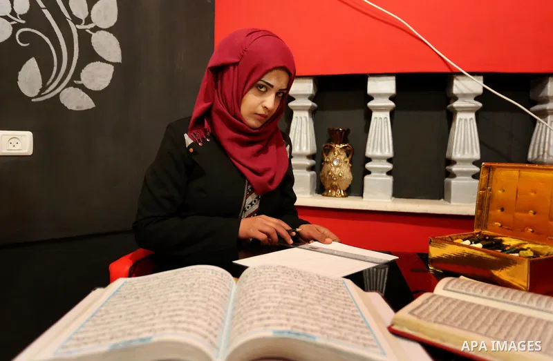 Saadia Akkad, a Palestinian woman, 25, print a copy of the Koran in a manner drawing Ottoman, at her house on February 22, 2017, in Khan Younis in the southern Gaza strip. Photo by Ashraf Amra
