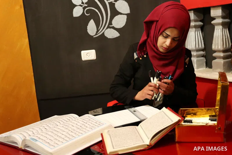 Saadia Akkad, a Palestinian woman, 25, print a copy of the Koran in a manner drawing Ottoman, at her house on February 22, 2017, in Khan Younis in the southern Gaza strip. Photo by Ashraf Amra