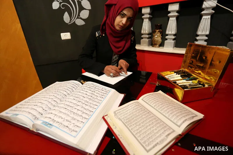 Saadia Akkad, a Palestinian woman, 25, print a copy of the Koran in a manner drawing Ottoman, at her house on February 22, 2017, in Khan Younis in the southern Gaza strip. Photo by Ashraf Amra