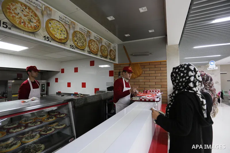 Palestinians shop in a new indoor shopping mall in the Gaza Strip, on February 23, 2017. In a welcome sign of normalcy, the first-of-its-kind indoor shopping mall -- complete with an international retail chain, three-sto...
