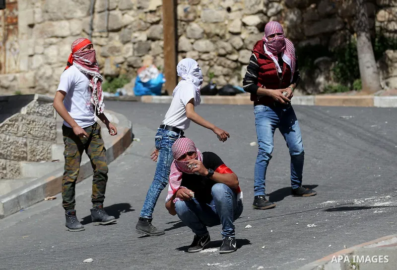 Palestinian protesters clash with Israeli security forces, during a demonstration calling for the opening of Shuhada Street, which is largely closed off to Palestinians, in the West Bank city of Hebron, coinciding with t...