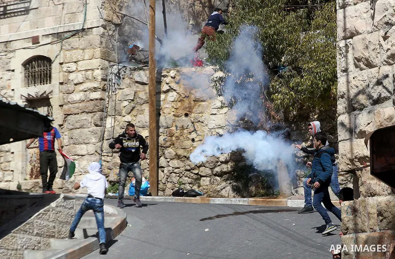 Palestinian protesters clash with Israeli security forces, during a demonstration calling for the opening of Shuhada Street, which is largely closed off to Palestinians, in the West Bank city of Hebron, coinciding with t...