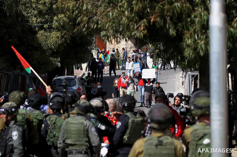 Palestinian and foreign protesters demonstrate, calling for the opening of Shuhada Street, which is largely closed off to Palestinians, in the West Bank city of Hebron, coinciding with the anniversary of a 1994 massacre...