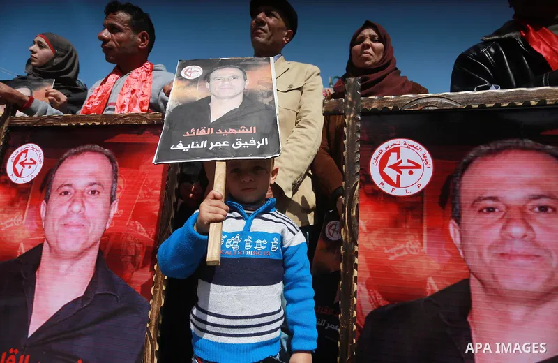 Palestinian supporters of the Popular Front for the Liberation of Palestine (PFLP), take part during a protest marking the first Anniversary of death of Palestinian Omar El-Nayef who was assassinated in Palestinian embas...