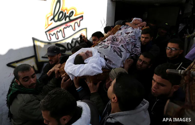Palestinians carry the body of Palestinian Abdullah Alnamula, 23, who died after inhaling toxic gas inside the tunnel along the border between the Gaza Strip and Egypt during his funeral in Rafah in the southern Gaza str...