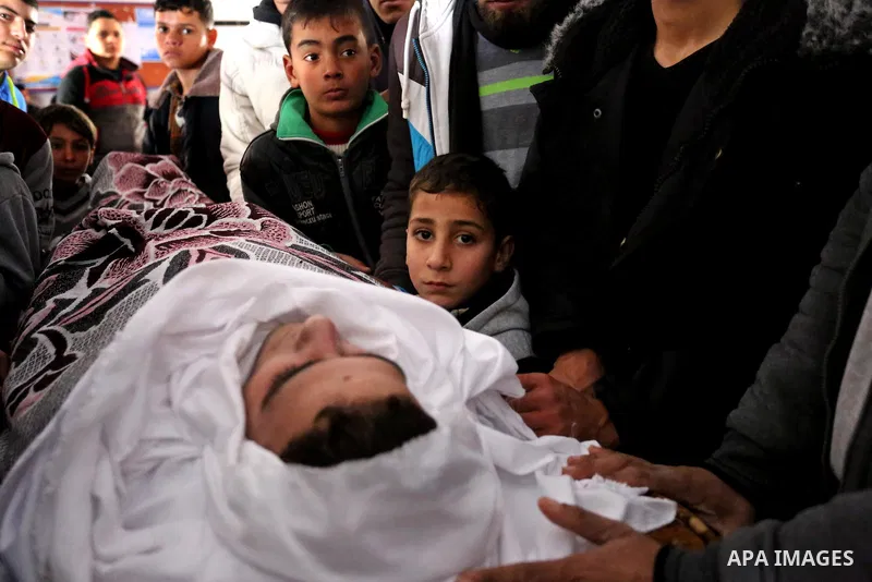 Palestinians mourn around the body of Palestinian Abdullah Alnamula, 23, who died after inhaling toxic gas inside the tunnel along the border between the Gaza Strip and Egypt during his funeral in Rafah in the southern G...