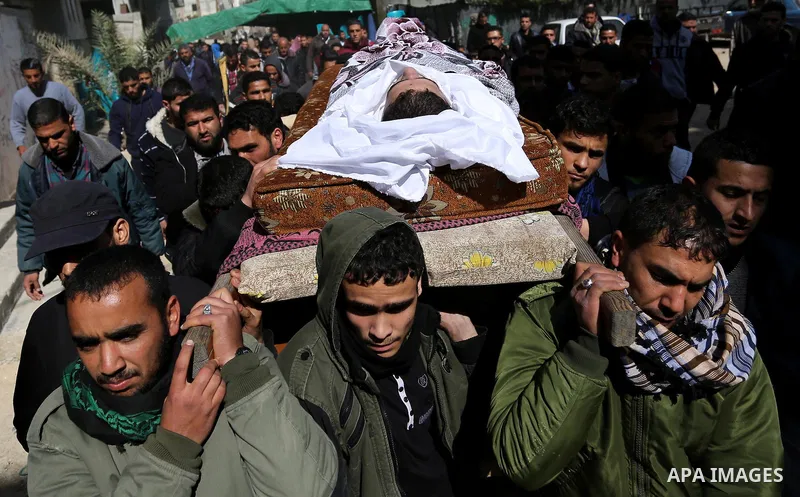 Palestinians carry the body of Palestinian Abdullah Alnamula, 23, who died after inhaling toxic gas inside the tunnel along the border between the Gaza Strip and Egypt during his funeral in Rafah in the southern Gaza str...