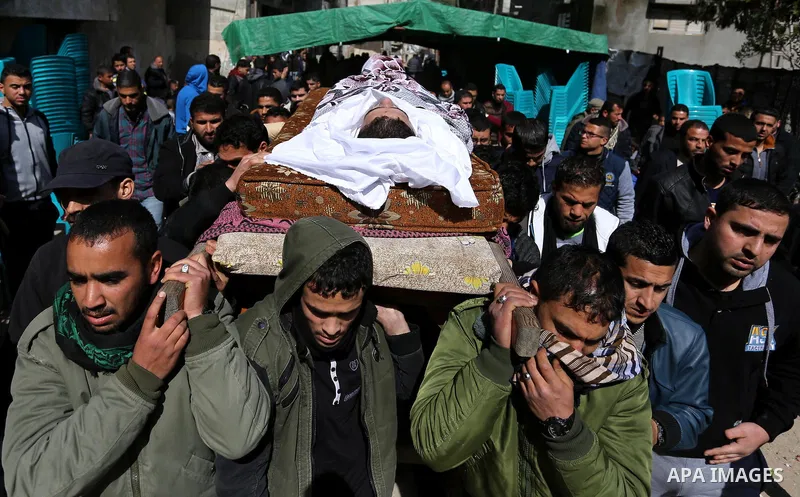 Palestinians carry the body of Palestinian Abdullah Alnamula, 23, who died after inhaling toxic gas inside the tunnel along the border between the Gaza Strip and Egypt during his funeral in Rafah in the southern Gaza str...