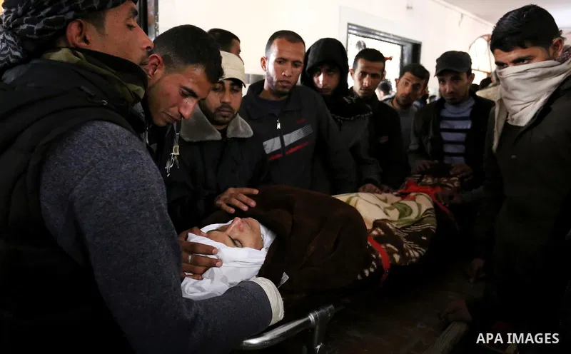 Palestinians mourn around the body of Palestinian Obeid Soufi, 25, who died after inhaling toxic gas inside the tunnel along the border between the Gaza Strip and Egypt during his funeral in Rafah in the southern Gaza st...