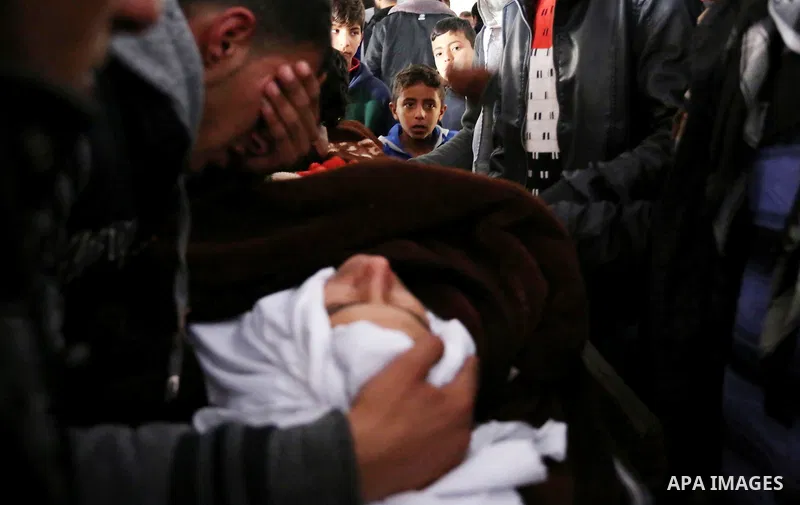 Palestinians mourn around the body of Palestinian Obeid Soufi, 25, who died after inhaling toxic gas inside the tunnel along the border between the Gaza Strip and Egypt during his funeral in Rafah in the southern Gaza st...