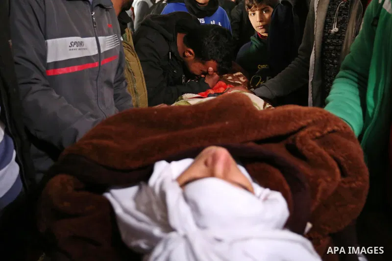 Palestinians mourn around the body of Palestinian Obeid Soufi, 25, who died after inhaling toxic gas inside the tunnel along the border between the Gaza Strip and Egypt during his funeral in Rafah in the southern Gaza st...