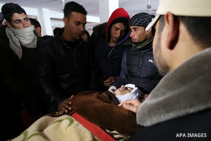 Palestinians mourn around the body of Palestinian Obeid Soufi, 25, who died after inhaling toxic gas inside the tunnel along the border between the Gaza Strip and Egypt during his funeral in Rafah in the southern Gaza st...