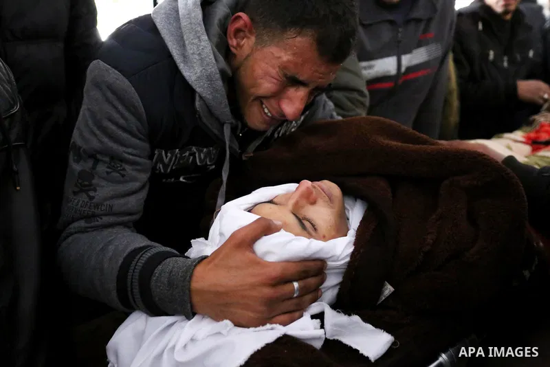 Palestinians mourn around the body of Palestinian Obeid Soufi, 25, who died after inhaling toxic gas inside the tunnel along the border between the Gaza Strip and Egypt during his funeral in Rafah in the southern Gaza st...