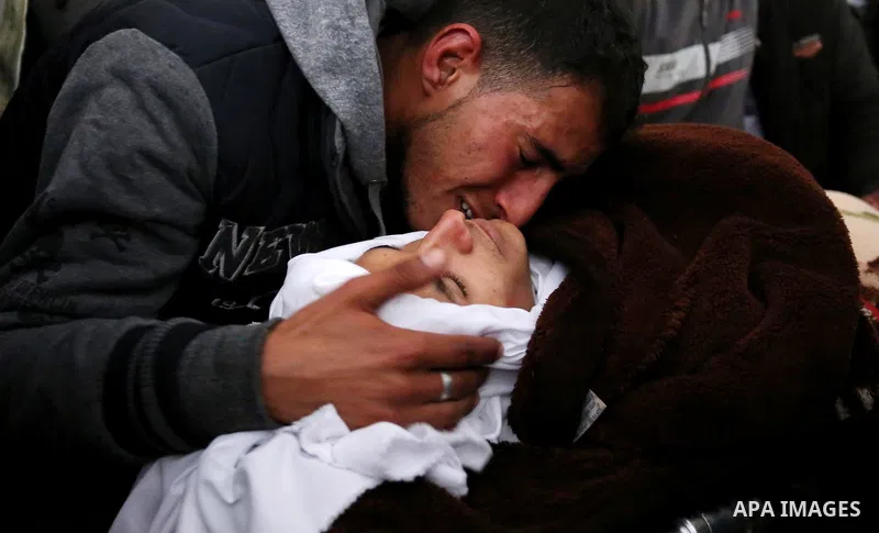 Palestinians mourn around the body of Palestinian Obeid Soufi, 25, who died after inhaling toxic gas inside the tunnel along the border between the Gaza Strip and Egypt during his funeral in Rafah in the southern Gaza st...