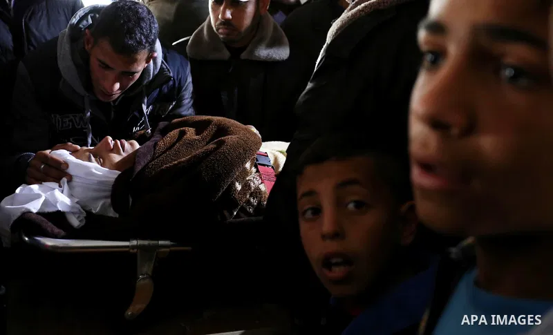 Palestinians mourn around the body of Palestinian Obeid Soufi, 25, who died after inhaling toxic gas inside the tunnel along the border between the Gaza Strip and Egypt during his funeral in Rafah in the southern Gaza st...