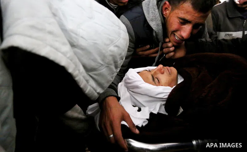 Palestinians mourn around the body of Palestinian Obeid Soufi, 25, who died after inhaling toxic gas inside the tunnel along the border between the Gaza Strip and Egypt during his funeral in Rafah in the southern Gaza st...